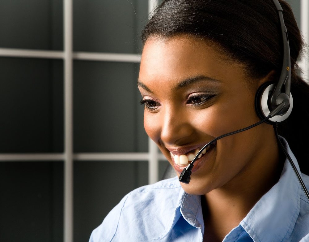 Smiling Timeline Travel consultant wearing a headset, ready to help travellers